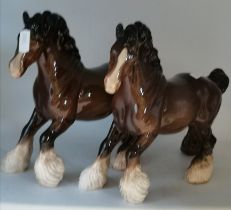 A pair of brown Beswick cantering shire horses