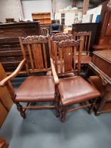 A set of 20th century oak dining chairs with crown carved decoration