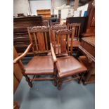 A set of 20th century oak dining chairs with crown carved decoration