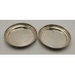 A pair of Elizabeth II silver bottle coasters