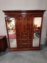 An Edwardian mahogany and inlaid triple wardrobe