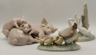 Two Nao porcelain animal figure groups, and a Lladro group