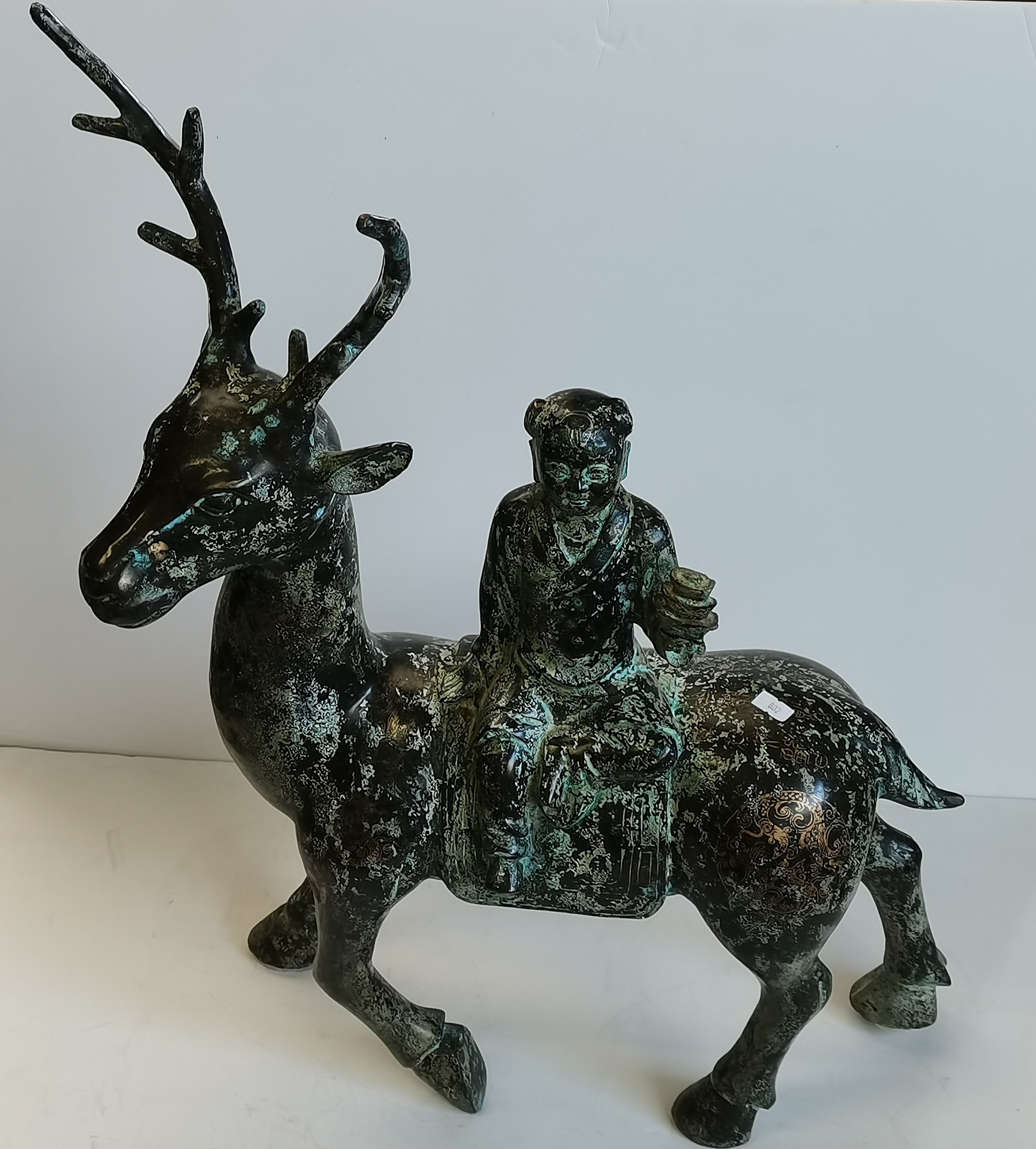 A Chinese bronzed metal sculpture of a figure riding a deer - Image 2 of 2