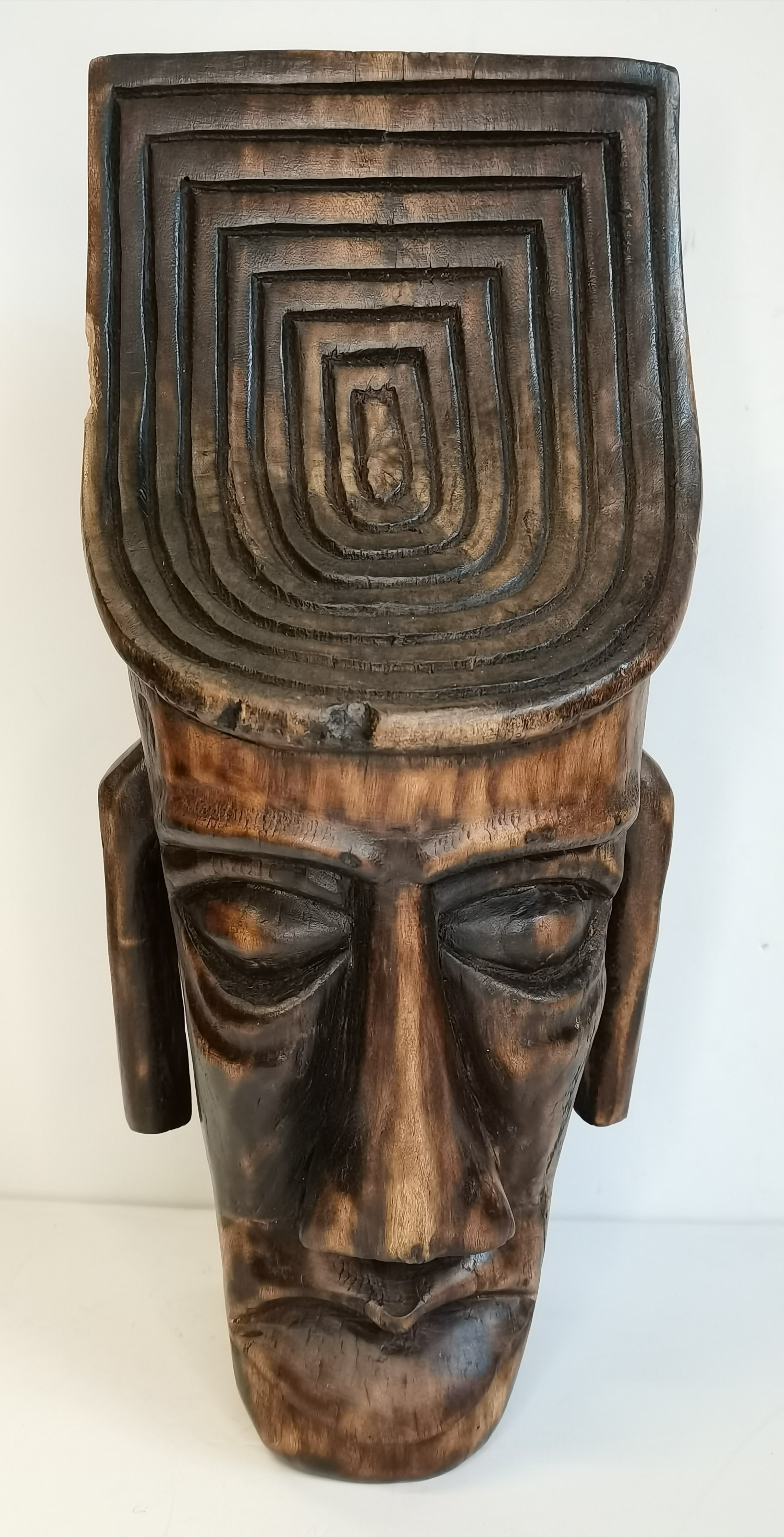 A vintage carved wooden mask