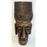 A vintage carved wooden mask