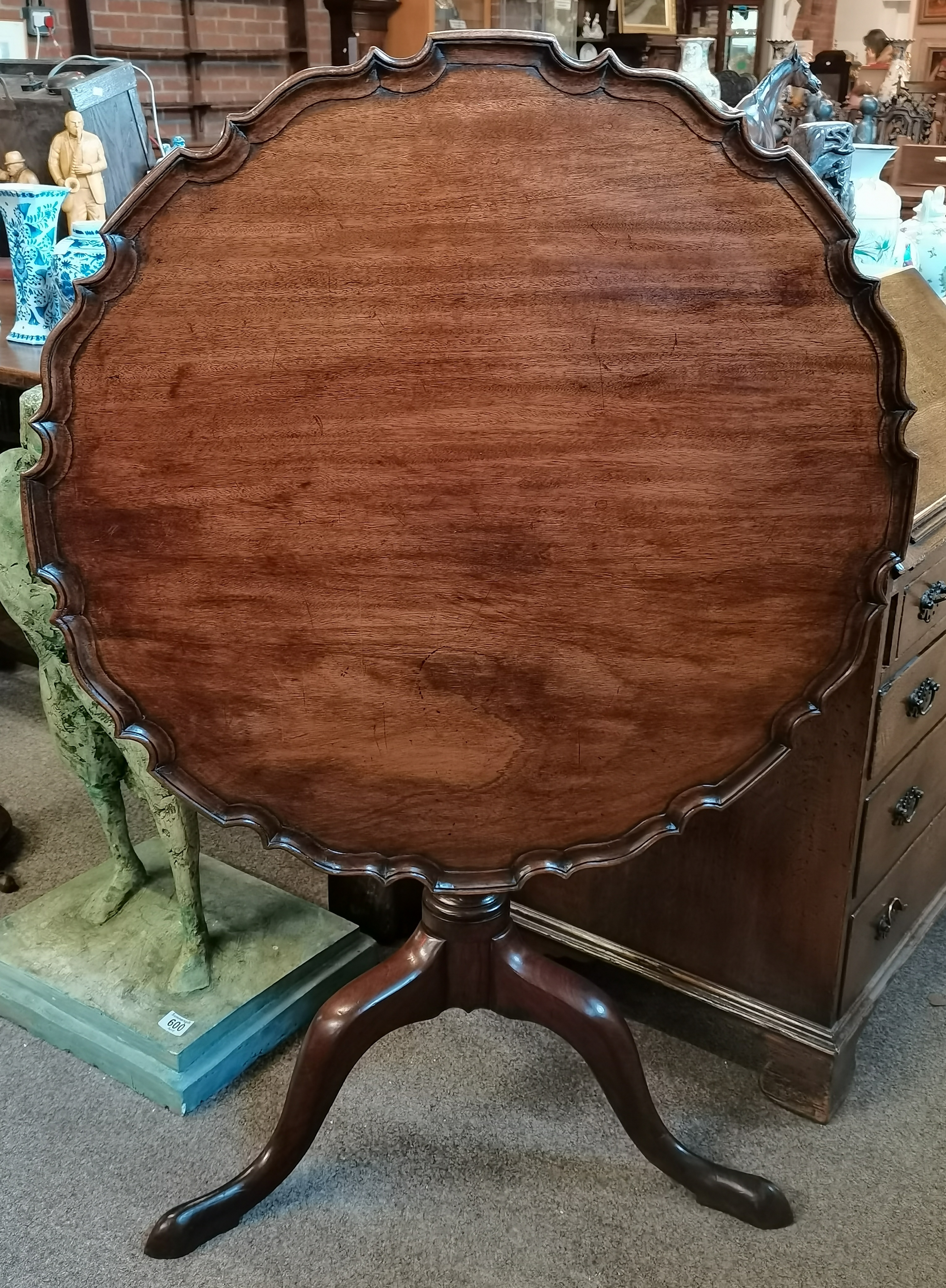 A Georgian mahogany pie crust edged tripod table w