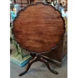 A Georgian mahogany pie crust edged tripod table w