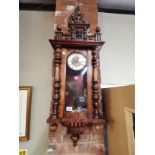 A Vienna wall clock with decorative finials and ho