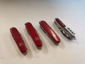 Four Swiss Army pocket knives