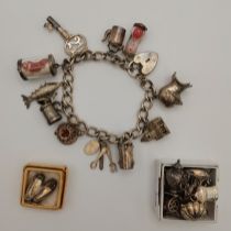 A silver charm bracelet with heart padlock clasp