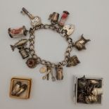 A silver charm bracelet with heart padlock clasp