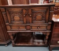 A Titchmarsh,arsh and Goodwin style carved oak sewing cabinet