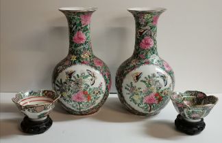 A pair of Chinese famille verte vases and a pair of small dishes to match