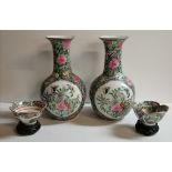 A pair of Chinese famille verte vases and a pair of small dishes to match