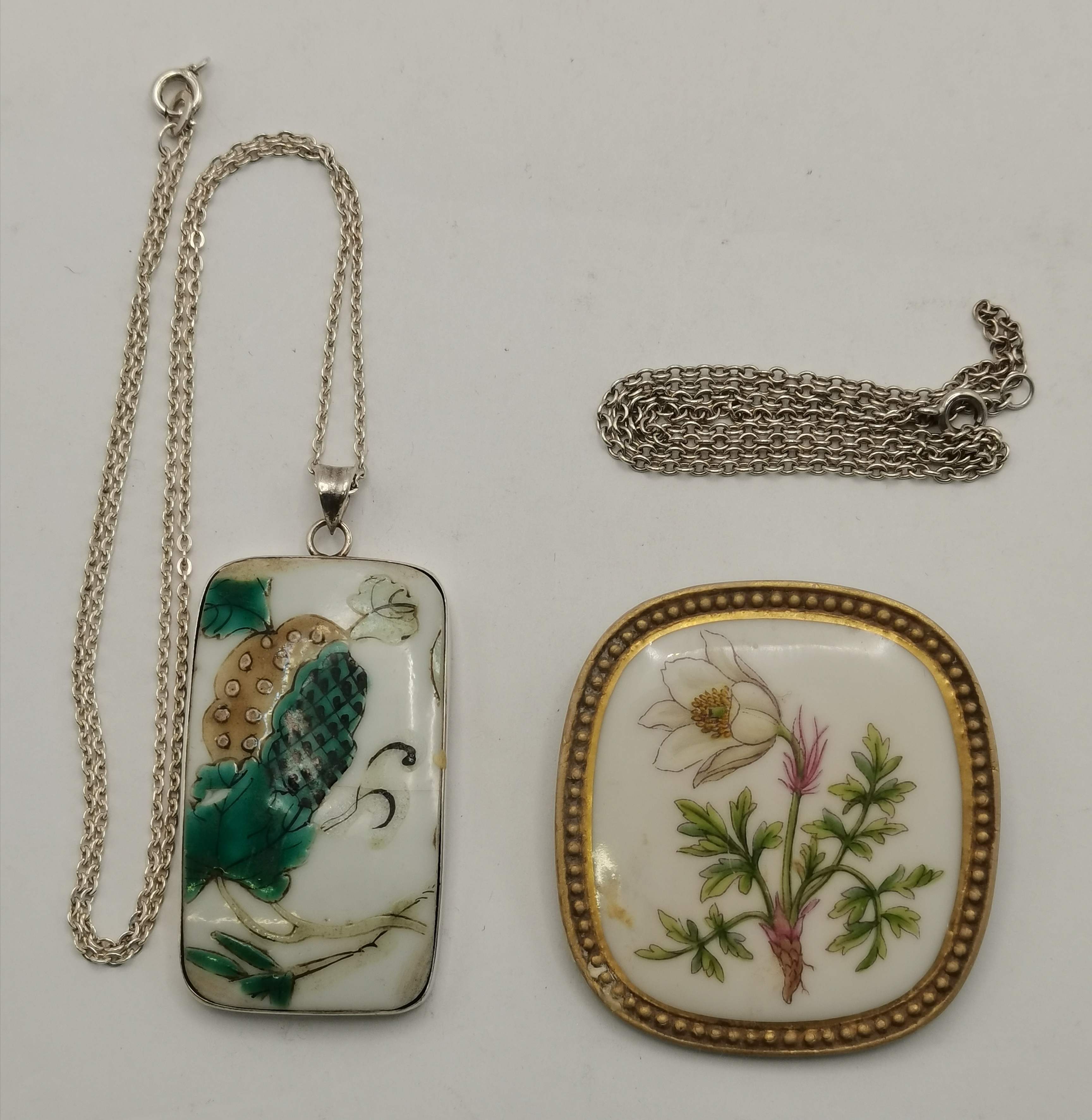 A silver-mounted Chinese porcelain plaque pendant, and a Danish silver-mounted porcelain brooch