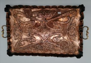 An Art Nouveau twin-handled copper tray