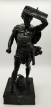 A large metal sculpture of a Roman warrior