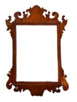 A 19TH CENTURY MAHOGANY AND PARCEL GILT FRETWORK FRAMED MIRROR Carved with a Hoho bird, along with