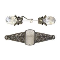 AN ART DECO WHITE METAL, MARCASITE AND FROSTED GLASS BROOCH The central floral panel set in a