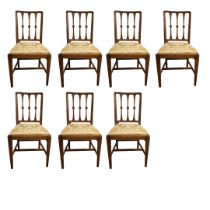 A SET OF EIGHT EDWARDIAN MAHOGANY DINING CHAIRS With roundel centred three columned backs recently