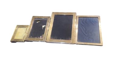 A COLLECTION OF FOUR SILVER PHOTOGRAPH FRAMES Graduated set with reeded border and easel backs,