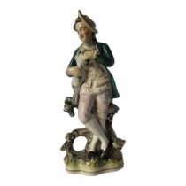 AN EARLY VICTORIAN STAFFORDSHIRE STATUE OF A GARDENER AND DOG, CIRCA 1840 Modelled in standing