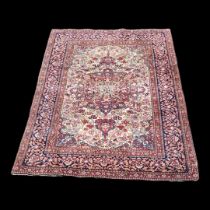 A VINTAGE PERSIAN WOOLLEN RUG With central floral field contained in running borders on a red and