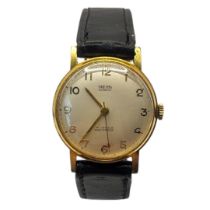 SMITHS, EVEREST, A 1950’S YELLOW METAL CASED GENT’S SLIM WRISTWATCH Having a gold tone dial,