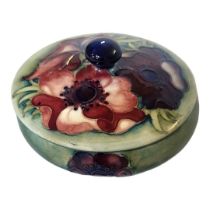 MOORCROFT, A MID 20TH CENTURY POTTERY POWDER JAR AND COVER In anemone pattern, the body tubelined