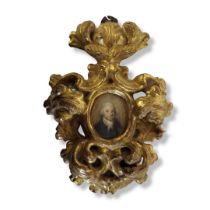 AN EARLY 19TH CENTURY OVAL MINIATURE PORTRAIT OF A GENTLEMAN In an elaborate giltwood frame. (22cm x