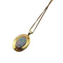 A VINTAGE YELLOW GOLD AND OPAL PENDANT NECKLACE The oval cut stone in a collet setting on a fine