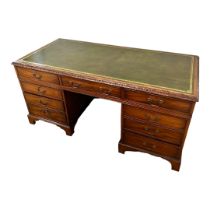A VICTORIAN STYLE MAHOGANY TWIN PEDESTAL DESK With green and gilt tooled leather writing surface
