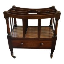 A VICTORIAN MAHOGANY FOUR SECTION CANTERBURY With single drawer, raised on turned legs terminating