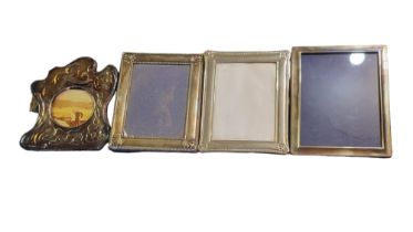 A COLLECTION OF FOUR 20TH CENTURY SILVER PHOTOGRAPH FRAMES To include an embossed frame with Art