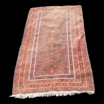 A CAUCASIAN WOOLEN RUG The central madder field within running orders. (117cm x 214cm) Condition: