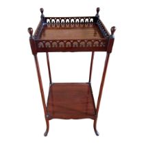 AN 18TH CENTURY STYLE MAHOGANY TWO TIER PLANT TABLE With turned finials above a pierced gothic