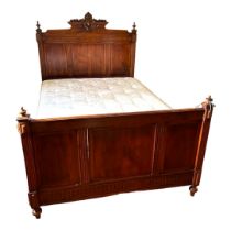 A LATE 19TH CENTURY FRENCH MAHOGANY DOUBLE BEDSTEAD With carved cartouche and turned finials above