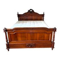 A 19TH CENTURY FRENCH MAHOGANY DOUBLE BEDSTEAD The headboard created with wreaths and torches,