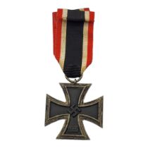 A WWII GERMAN IRON CROSS MEDAL Marked with swastikas, dated 1813 and 1939, with black white and