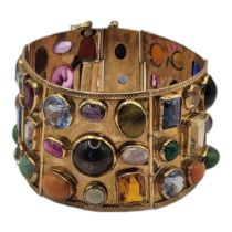 A VINTAGE YELLOW METAL AND GEM SET 'TUTTI FRUTTI' BRACELET Five panels set with various gemstones