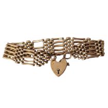 A VINTAGE 9CT GOLD GATE BRACELET Five bar with heart form lock, in fitted velvet box. (approx 9cm)