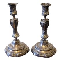 A PAIR OF LATE ELKINGTON MANNER 19TH CENTURY SOLID SILVER PLATED GEORGE II STYLE CANDLESTICKS