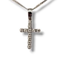 A VINTAGE 9CT WHITE GOLD AND DIAMOND CRUCIFIX PENDANT NECKLACE Set with round cut diamonds on fine