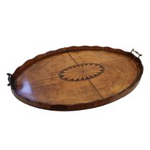 A GEORGIAN MAHOGANY OVAL BUTLAR'S TRAY Twin brass handles, scrolled gallery and central inlaid