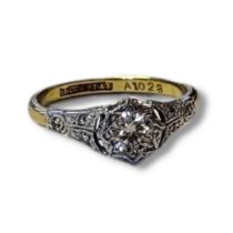 AN EARLY 20TH CENTURY 18CT GOLD AND DIAMOND SOLITAIRE RING Having a single round cut diamond and