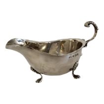 AN EARLY 20TH CENTURY SILVER SAUCE BOAT Having a scrolled handle, hallmarked Birmingham, 1900, on