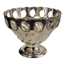 AN EDWARDIAN SILVER BOWL Having a scrolled edge,pierced border and wreathed flutes to base,