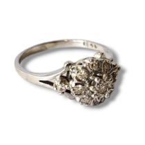 A VINTAGE 18CT WHITE GOLD AND DIAMOND RING Having an arrangement of round cut diamonds forming a