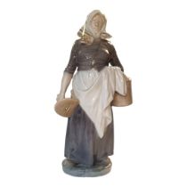 CHRISTIAN THOMPSON FOR ROYAL COPENHAGEN, A HARD PASTE PORCELAIN FIGURE OF A DUTCH FARMER WOMAN,