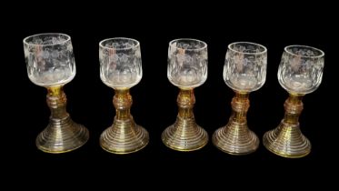 A SET OF FIVE EARLY 20TH CENTURY GERMAN 'ROAMER' AMBER GLASSES Having etched and fluted bowls with